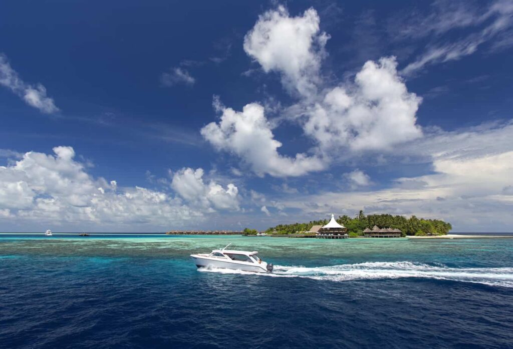 Speedboat in the Maldives heading towards a resort jetty in North Malé Atoll